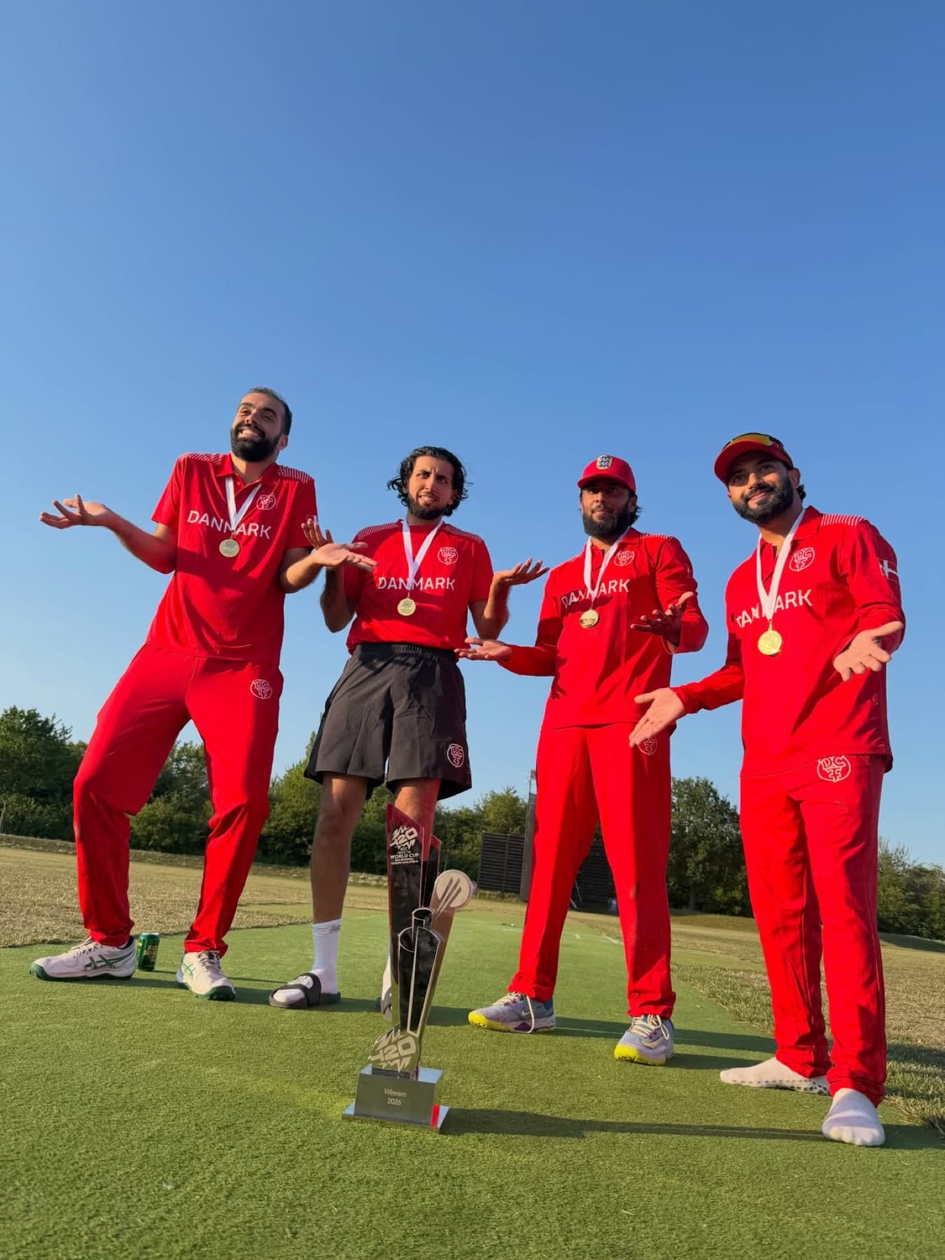 Denmark players in red kit celebrating on the outfield